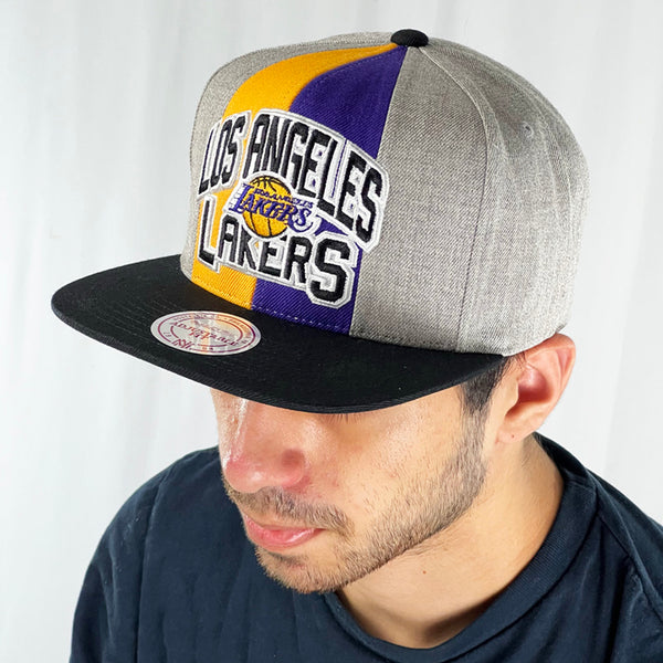 Support the LA Lakers with this classic tall and proud grey snapback cap. Crafted with a high structured crown and fully fitted for your complete comfort in a range of sizes, it is finished with a flat visor and LA Lakers logo embroidery and Mitchell & Ness embroidery to rear Colour: Grey Brand New with Tags - Size on Tag: One Size