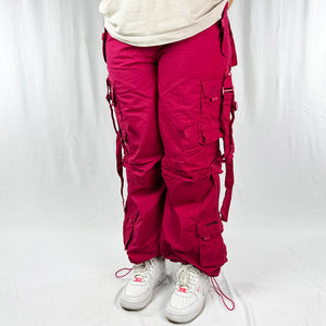 Super cute Youth Deadstock Vintage Criminal Damage parachute cargo trousers in black with Criminal Damage embroidered logo. Cord to waist. Plenty of pockets to sides and back. Lattice carnaby style. Adjustable cord to hem. Due to age you may need to tie the pull cord to keep in place Material: Polyester/Cotton Condition: Brand new with tags Measurements: - Size on Tag: Youth L/B (fits adult small) Length: 40 Inches Inseam: 28.5 Inches Waist: 24-33 Inches