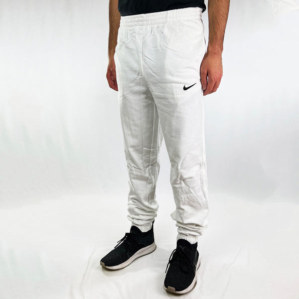 90s Deadstock Vintage Nike swoosh joggers in white. Nike swoosh logo to front. Pockets to sides. Adjustable drawstrings to waist. cuffed hem. - Materials: 95% Cotton - 5% Polyester - Colour: White Brand New with Tags