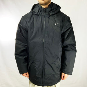 Y2k Deadstock Vintage Nike Swoosh Jacket in black with big swoosh logo on back. Detachable hood by zip. Colour: Black Brand New with Tags Size on Tag: Large MEASUREMENTS: Pit to Pit: 26 INCHES Length: 32 INCHES All our items are of vintage conditions. This means some items may show signs of minor wear. Any major defects will be pictured and stated in the description