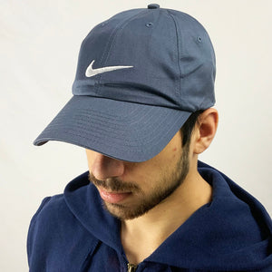 2003 Deadstock Vintage Nike Swoosh Cap in Blue with embroidered Nike Swoosh to centre. Hat is adjustable at back. Colour: Blue Brand New with Tags - Size on Tag: Adult Unisex All our items are of vintage conditions. This means some items may show signs of minor wear. Any major defects will be pictured and stated in the description
