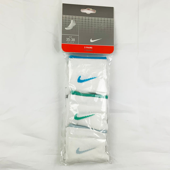 3 Per Pack Y2k Women's Deadstock Vintage Nike Sports Socks in White. Socks has 3 different coloured Nike Swoosh. Blue swoosh, green swoosh and light blue swoosh Colour: White  Brand New with Tags -  Size on Tag: 2.5 - 5  All our items are of vintage conditions. This means some items may show signs of minor wear. Any major defects will be pictured and stated in the description