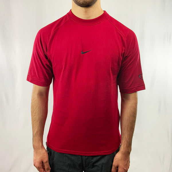 Y2k Boys Deadstock Vintage Nike Team T-shirt in red with embroidered Nike swoosh to chest and Nike Football logo to arm. Perfect for summer. Colour: Red Brand New with Tags _ Size on Tag: Boys XL (fits adult small) Measurements: Pit to Pit: 18.5 Inches Length: 26.5 Inches  All our items are of vintage conditions. This means some items may show signs of minor wear. Any major defects will be pictured and stated in the description