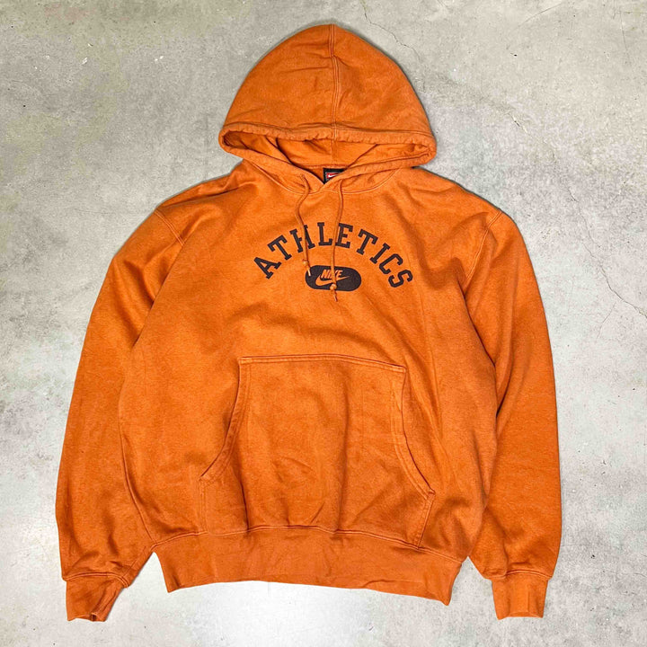 Vintage Nike athletics hoodie in orange with spellout across chest. Drawstrings to hood.  Condition: Good  Size on Tag: Medium Measurements: Pit to Pit: 25.5 Inches Length: 27 Inches