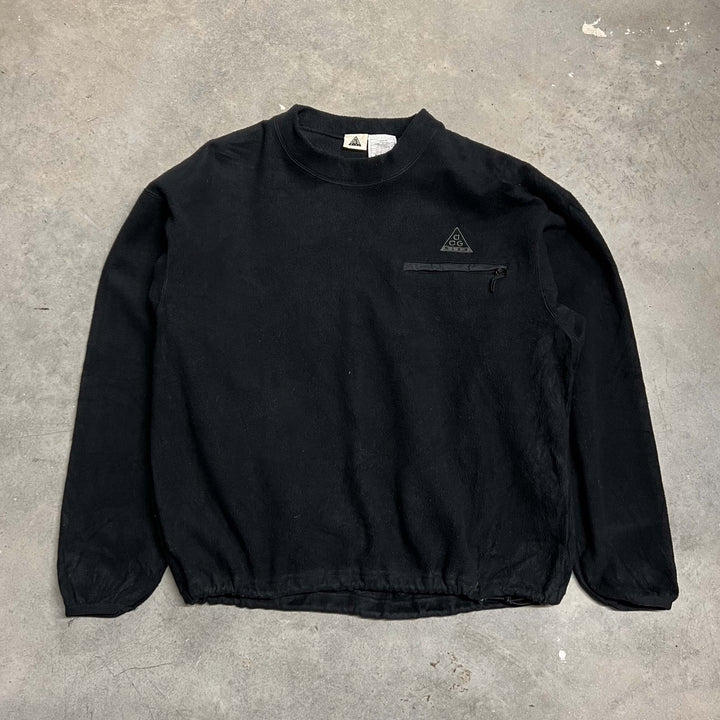 Vintage Nike ACG sweatshirt in black. ACG logo to chest with zip pocket under. Adjustable hem. Crew neck. Condition: Good - Size on Tag: Medium Measurements: Pit to Pit: 25 Inches Length: 25.5 Inches
