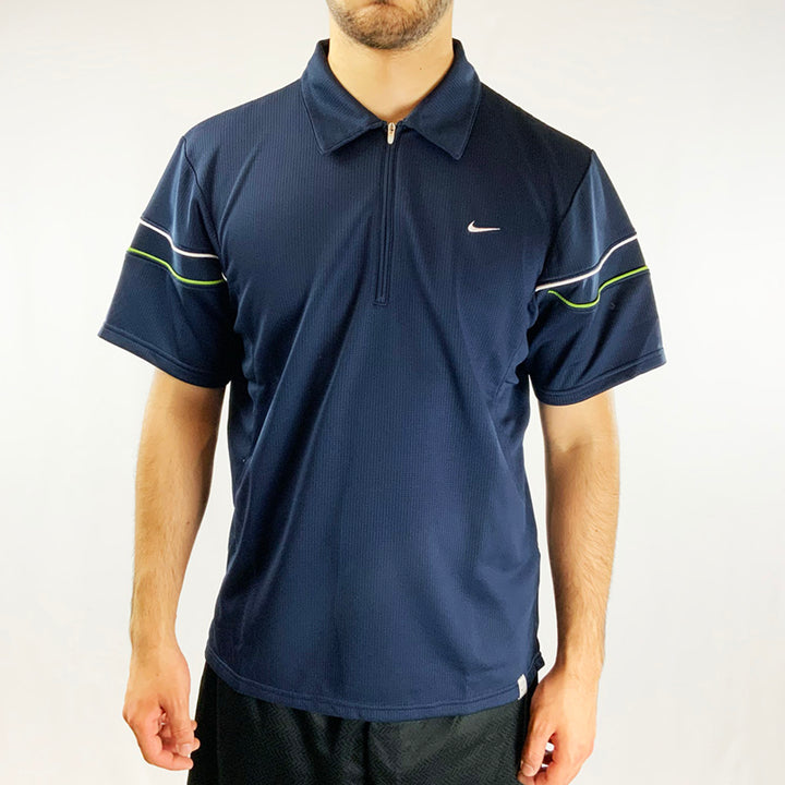2004 Deadstock Vintage Nike Court Polo T-shirt in Navy Blue with Nike swoosh to chest. Dri-Fit technology. 1/2 zip closure. Polyester material. Colour: Navy Blue  Brand New with Tags  _  Size on Tag: Medium Measurements:  Pit to Pit: 22 Inches  Length: 28 Inches  All our items are of vintage conditions. This means some items may show signs of minor wear. Any major defects will be pictured and stated in the description