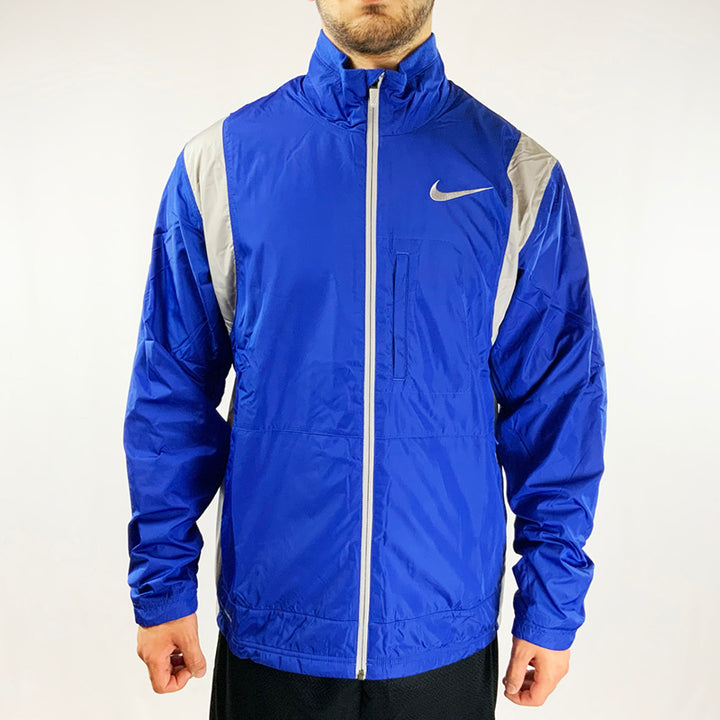2009 Deadstock Vintage Nike Storm Fit Fleeced Jacket in blue. Storm-Fit technology and fleeced inner layer. Zip pockets on side, pocket to chest area and pockets under arm. Swoosh to chest. Polyester material. Colour: Blue Brand New with Tags