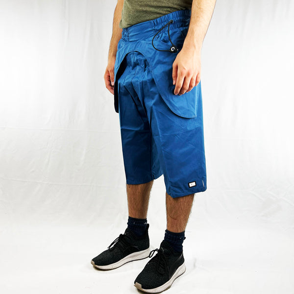 Y2K Deadstock Vintage Nike Swoosh shorts in blue. Nike swoosh to front. Stretch to waist and adjustable cord to side. Pockets to outer shorts on side. Material: Cotton  Colour: Blue  Brand New with Tags