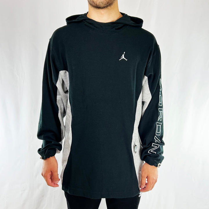 90s Deadstock Vintage Jordan Spellout Hoodie in Black with embroidered Air Jordan logo to chest and spellout to sleeve. Zip pocket for your essentials. Adjustable cord to wrist.  Colour: Black Material: Cotton/Polyester Brand New with Tags