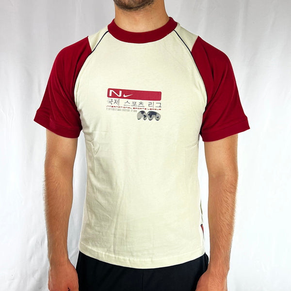 Boys Y2K Deadstock Vintage Nike International Sports League T-shirt in cream with red sleeves. Nike branding across chest. Limited edition. Perfect for summer. 
