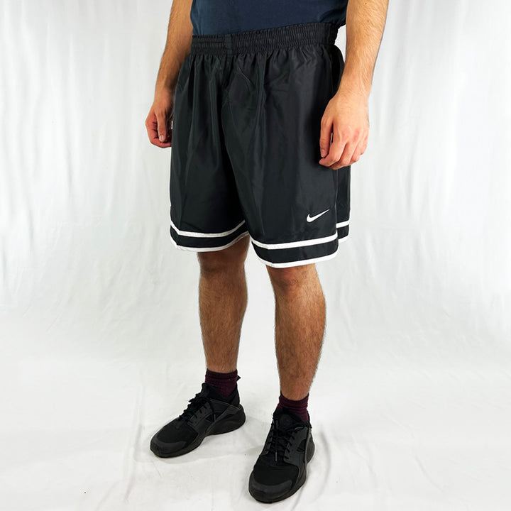 90s Deadstock Vintage Nike Team Philips shorts in black. Embroidered Nike swoosh and Philips spellout. Adjustable drawstring to waist. Pockets to sides and rear. Perfect for summer and sports. Material: Polyester Colour: Black Brand New with Tags - Size on Tag: XL Measurements: Length: 18 Inches Waist: Adjustable drawstrings