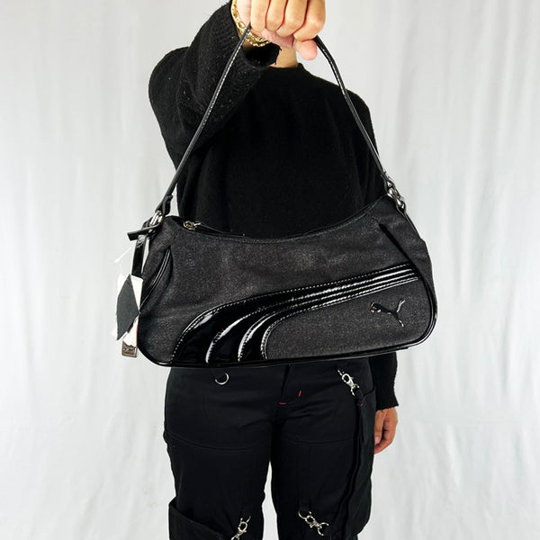 Your sports outfit will not be as attractive without the Puma dazzle hobo bag. Black in colour, it has the metallic Puma logo on the front and Puma spellout to handle. It has a compartment with an inner pocket. Materials: Cotton Colour: Black Brand New with Tags  Length: 12 inches Height: 5 inches