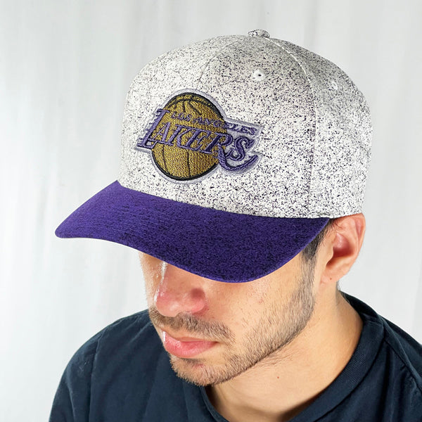 Support the Los Angeles Lakers with this low profile snapback cap. Finished in white with purple dots and paired with a purple flat visor, the fitted crow features the LA Lakers logo fully fitted for your complete comfort in a range of sizes. Mitchell & Ness embroidery to rear Colour: White & Purple Brand New with Tags - Size on Tag: One Size