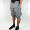Y2k Deadstock Vintage Nike Sportswear cargo shorts in grey with black triangle pattern. Embroidered Nike logo. Adjustable waist. Pockets to sides and rear. Adjustable cord at hem. Perfect for summer. Material: Polyester Colour: Grey Brand New with Tags - Size on Tag: Medium Measurements: Length: 22.5 Inches Waist: GB 30/32 (can also fit larger sizes due to flexible waist)
