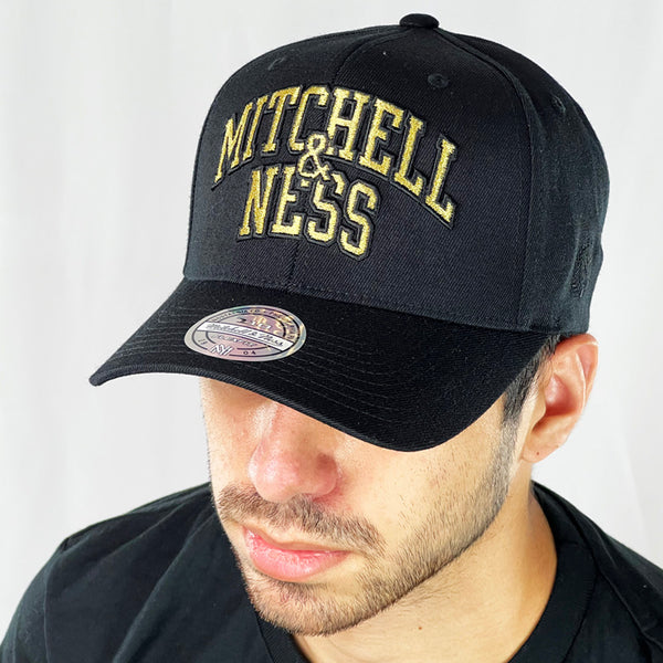 Mitchell & Ness low profile snapback cap. Finished in black and paired with a curved visor, the fitted crow features the spellout Mitchell & Ness logo fully fitted for your complete comfort in a range of sizes. Mitchell & Ness embroidery to rear Colour: Black Brand New with Tags - Size on Tag: One Size