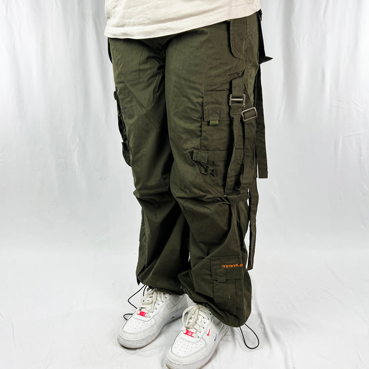 Super cute Youth Deadstock Vintage Criminal Damage parachute cargo trousers in khaki with Criminal Damage embroidered logo. Cord to waist. Plenty of pockets to sides and back. Lattice carnaby style. Adjustable cord to hem. Due to age you may need to tie the pull cord to keep in place Material: Polyester/Cotton Condition: Brand new with tags Measurements:  - Size on Tag: Youth L/B (fits adult small) Length: 39 Inches Inseam: 29 Inches Waist: 24-33 Inches