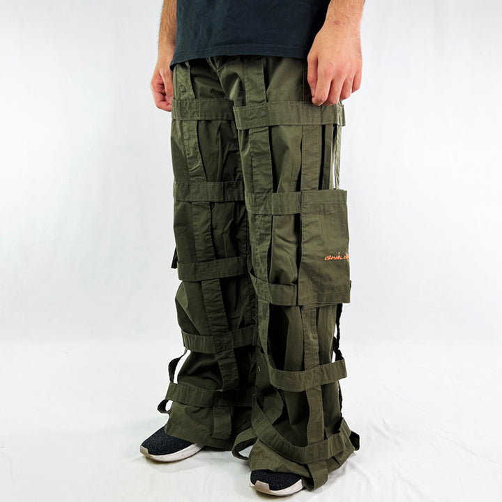 Deadstock Vintage Criminal Damage Lattice Cargo Trousers in khaki with Criminal Damage branding. High-waisted trousers. Pockets to sides. Belt loops for belt adjustment. - Materials: Polyester/Cotton Condition: Brand new with tags