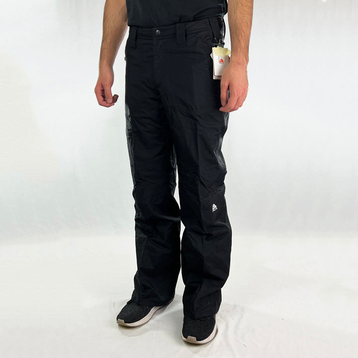 Y2K Women's Deadstock Vintage Nike ACG Cargo Ski Pants in black with Nike ACG branding. Storm-Fit technology. Thermore light insulation fleeced inner layer. Zip pockets to sides. Boot gaiters. Belt loops for belt adjustment. - Materials: Nylon - Colour: Black Brand New with Tags