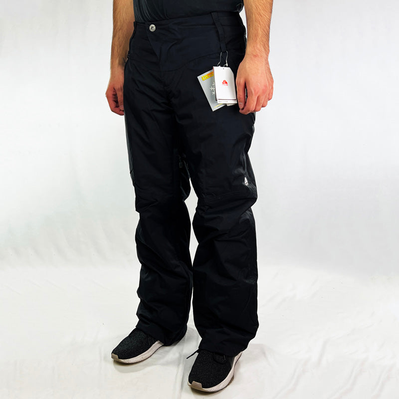 Y2K Women's Deadstock Vintage Nike ACG Cargo Ski Pants in black with Nike ACG branding. Storm-Fit technology. Thermore light insulation fleeced inner layer. Zip pockets. Boot gaiters. Belt loops for belt adjustment. - Materials:  Body: Nylon Fill: Polyester