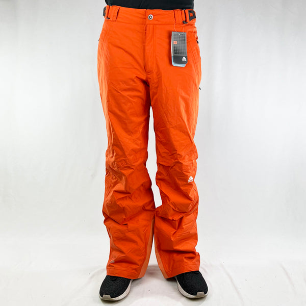 Y2K Women's Deadstock Vintage Nike ACG Cargo Ski Pants in orange with Nike ACG branding. Storm Fit 5 technology to keep you comfortable and dry in rain, sleet, and snow. Fleeced inner layer. Zip pockets. Boot gaiters. Belt loops for belt adjustment. - Materials: Nylon/Polyester - Colour: Orange Brand New with Tags