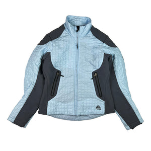 Y2K Women's Deadstock Vintage Nike ACG padded jacket in blue and grey. Nike ACG logo to waist. Zip closure to jacket. Zip pockets to front. Inner pockets. Adjustable cord to waist. Gorpcore style. - Material: 100% Polyester - Colour: Blue Brand New with Tags - Size on Tag: Medium Measurements: Pit to Pit: 19 Inches Length: 24 Inches