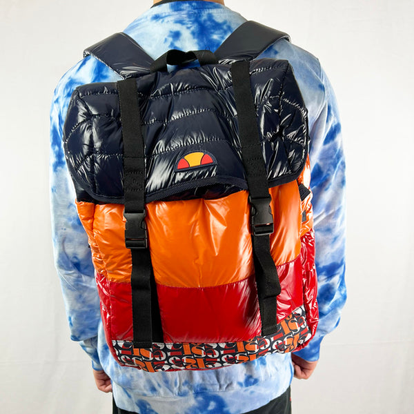 Ellesse Montagna Backpack bag in multicolour. The perfect way to style up any outfit, this backpack has zip pockets to both sides. Large compartment with drawstring closure and straps. Logo on the front. Colour: Multi Brand New with Tag Materials: Shell: 95% Nylon - 5% Polyester Lining: 100% Polyester