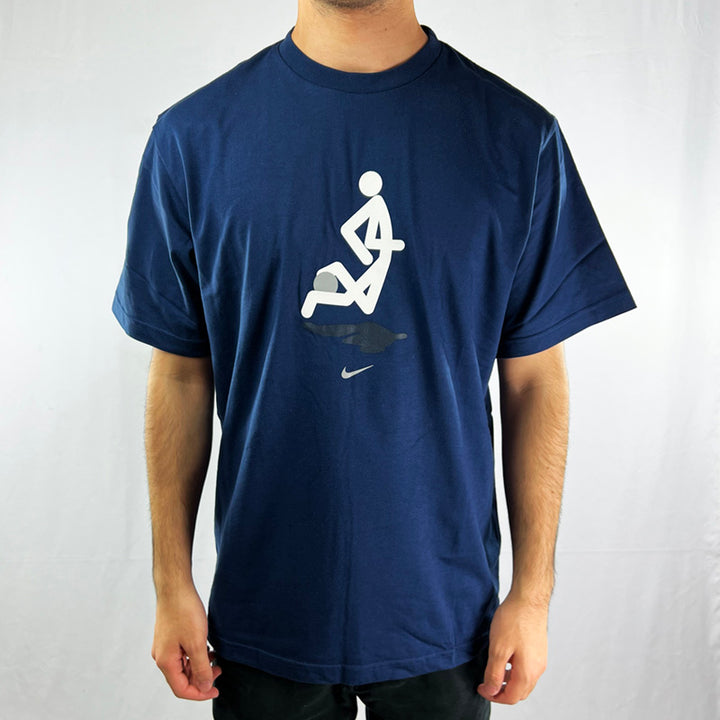 Y2K Deadstock Vintage Nike football t-shirt in navy blue. Stick man graphic to front with nike swoosh. Swoosh to shoulder. Crew neck t-shirt. - Material: 100% Cotton Colour: Navy Blue Brand New with Tags - Size on Tag: Large Measurements: Pit to Pit: 22 Inches Length: 29 Inches