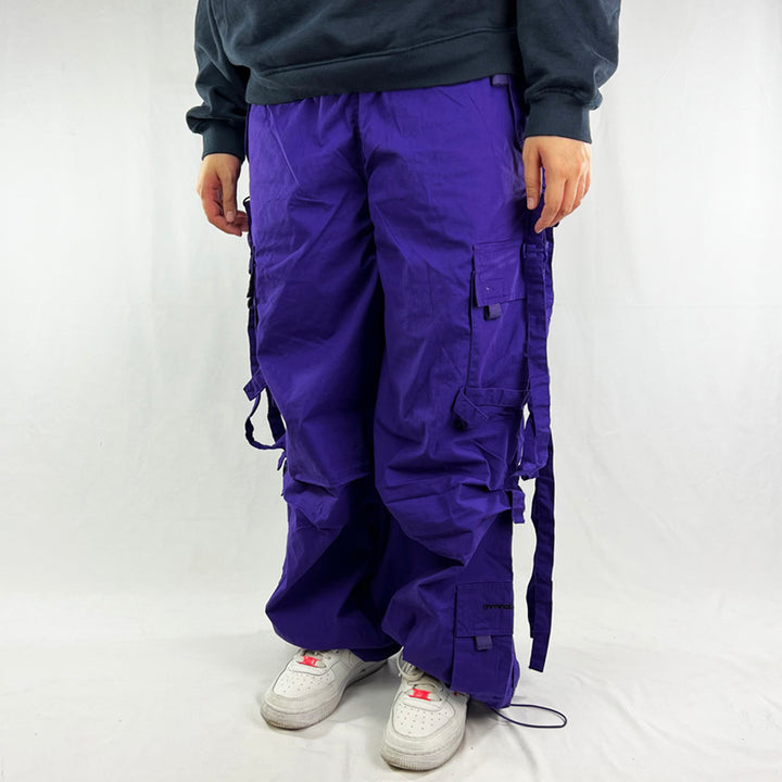 Super cute ﻿Deadstock Vintage Criminal Damage parachute cargo trousers in purple with Criminal Damage embroidered logo. Cord to waist. Plenty of pockets to sides and back. Lattice carnaby style. Adjustable cord to hem. Due to age you may need to tie the pull cord to keep in place Material: Polyester/Cotton