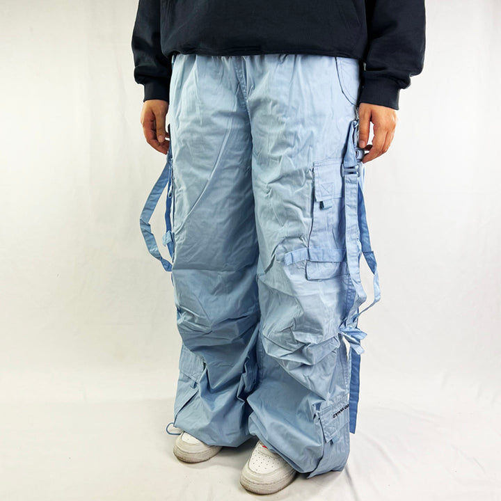 ﻿Deadstock Vintage Criminal Damage parachute cargo trousers in light blue with Criminal Damage embroidered logo. Cord to waist. Plenty of pockets to sides and back. Carnaby style. Adjustable cord to hem. Due to age you may need to tie the pull cord to keep in place Material: Polyester/Cotton Condition: Brand new with tags
