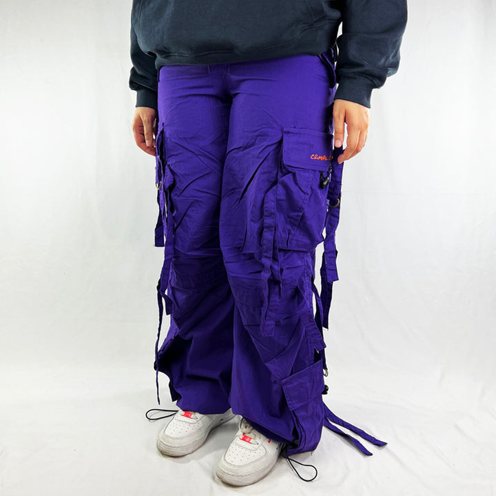 Super cute ﻿Deadstock Vintage Criminal Damage parachute cargo trousers in purple with Criminal Damage embroidered logo. Cord to waist. Plenty of pockets to sides and back. Drome style. Adjustable cord to hem. Due to age you may need to tie the pull cord to keep in place Material: Polyester/Cotton Condition: Brand new with tags