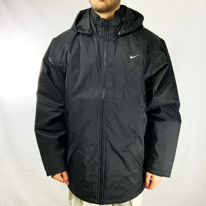 Y2k Deadstock Vintage Nike Swoosh Jacket in black with big swoosh logo on back. Detachable hood by zip. Colour: Black Brand New with Tags Size on Tag: Large MEASUREMENTS: Pit to Pit: 26 INCHES Length: 32 INCHES All our items are of vintage conditions. This means some items may show signs of minor wear. Any major defects will be pictured and stated in the description