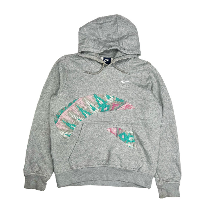 Vintage reworked Nike x COOGI Hoodie in grey with Swoosh logo to chest. Drawstrings to hood. Kangaroo pocket to front. - Colour: Grey Condition: Good  some marks to hoodie as seen in images may be washable.  - Size on Tag: Small Measurements: Pit to Pit: 21 Inches Length: 24 Inches  All our items are of vintage conditions. This means some items may show signs of minor wear. Any major defects will be pictured and/or stated in the description. We recommend to wash all vintage items before use.