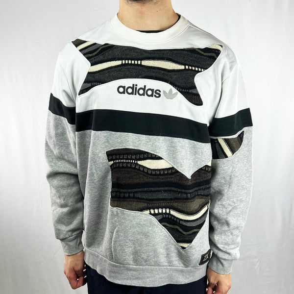 Vintage reworked Adidas x COOGI Sweatshirt in grey, black and white with spellout logo to chest. Crewneck. - Colour: Grey Condition: Good  - Size on Tag: Large Measurements: Pit to Pit: 23 Inches Length: 27 Inches  All our items are of vintage conditions. This means some items may show signs of minor wear. Any major defects will be pictured and/or stated in the description. We recommend to wash all vintage items before use.
