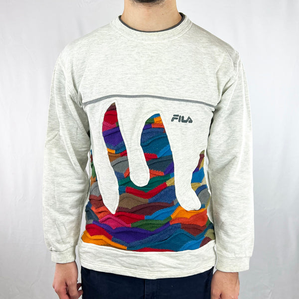 Vintage reworked Fila x COOGI Sweatshirt in white with spellout logo to chest. Crewneck. - Colour: White Condition: Good  - Size on Tag: Small Measurements: Pit to Pit: 19.5 Inches Length: 25.5 Inches  All our items are of vintage conditions. This means some items may show signs of minor wear. Any major defects will be pictured and/or stated in the description. We recommend to wash all vintage items before use.