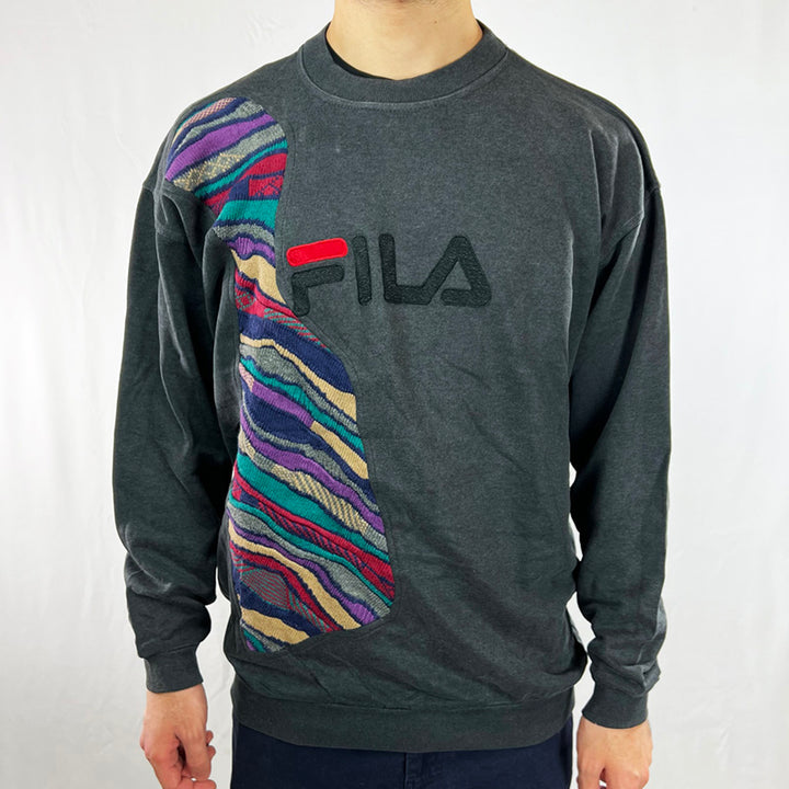 Vintage reworked Fila x COOGI Sweatshirt in dark grey with large spellout logo to chest. Crewneck. - Colour: Dark Grey Condition: Good  - Size on Tag: Large Measurements: Pit to Pit: 24.5 Inches Length: 28 Inches  All our items are of vintage conditions. This means some items may show signs of minor wear. Any major defects will be pictured and/or stated in the description. We recommend to wash all vintage items before use.