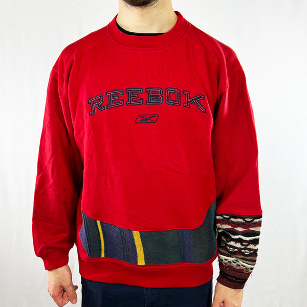 This REWORK Reebok x COOGI Sweatshirt is an iconic piece of 90s fashion style. Its comfortable crewneck design features a reworked pattern and a spell out logo. Experience retro fashion with a modern twist and express your unique style with this one-of-a-kind sweatshirt! Condition: Good  - Size on Tag: Medium Measurements: Pit to Pit: 23.5 Inches Length: 24.5 Inches