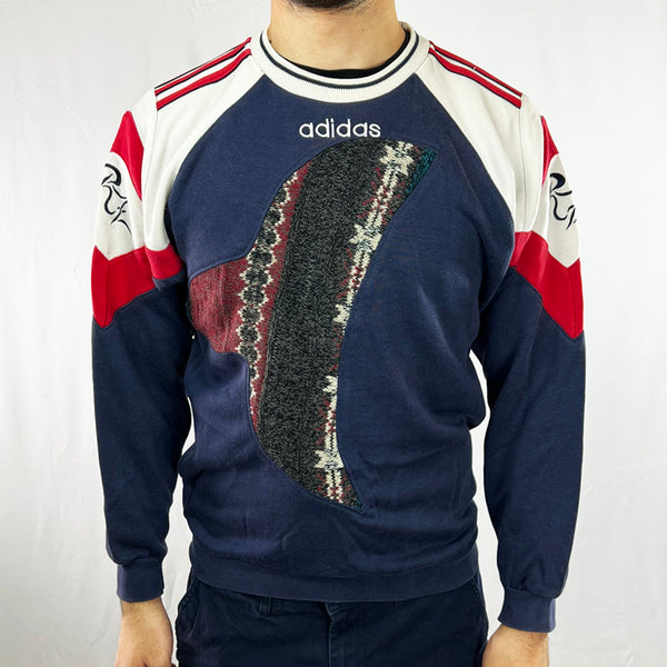 COOGI-style navy sweatshirt. Step into the '90s style with this unique REWORK Adidas x COOGI Sweatshirt. Perfectly tailored with stripes, this statement piece is an ideal way to make a style statement. Comfortably cozy and timelessly stylish, make this sweat your go-to for a modern twist on retro fashion! Condition: Good  - Size on Tag: Large Measurements: Pit to Pit: 20.5 Inches Length: 25 Inches