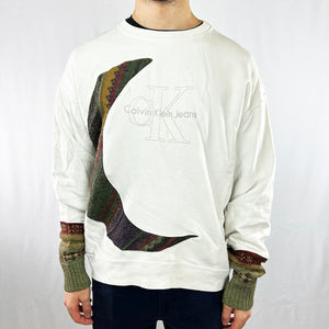 COOGI-style white sweatshirt. Step into the '90s style with this unique REWORK Calvin Klein x COOGI Sweatshirt. This statement piece is an ideal way to make a style statement. Comfortably cozy and timelessly stylish, make this sweat your go-to for a modern twist on retro fashion! Condition: Good  - Size on Tag: XL Measurements: Pit to Pit: 24.5 Inches Length: 26 Inches
