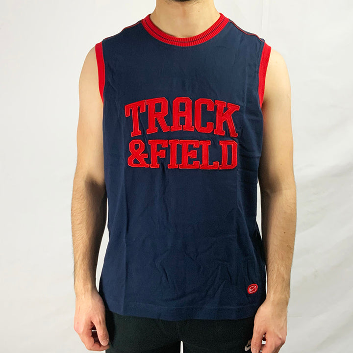 2003 Deadstock Vintage Nike Track and Field Vest Top in navy blue with red detailing. Nike branding to front. Colour: Navy Blue Brand New with Tags _ Size on Tag: Large Measurements: Pit to Pit: 21.5 Inches Length: 27 Inches  All our items are of vintage conditions. This means some items may show signs of minor wear. Any major defects will be pictured and stated in the description