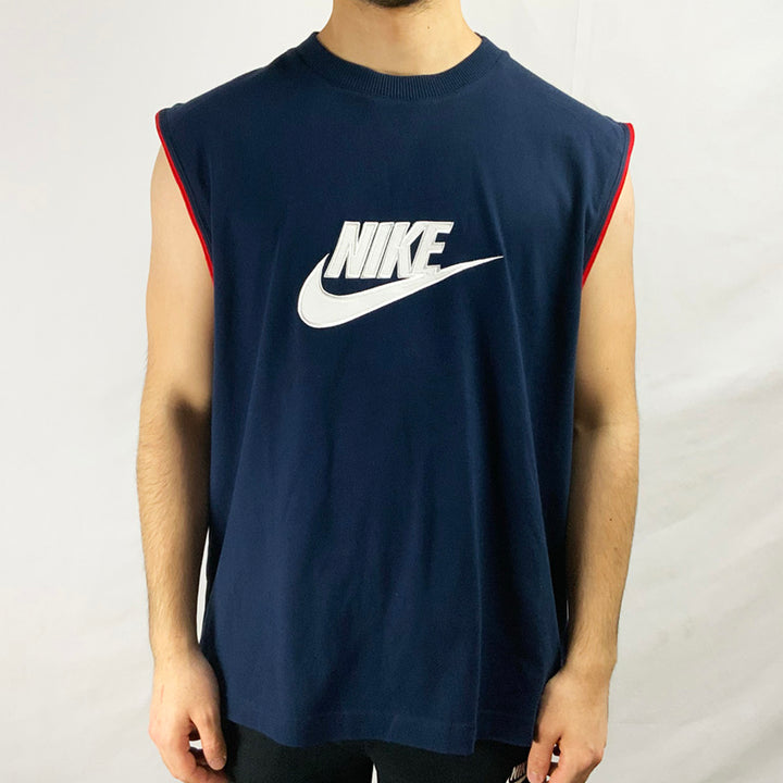 2004 Deadstock Vintage Nike Spellout Vest Top in navy blue with red detailing. Nike spellout logo on chest in white. Colour: Navy Blue Brand New with Tags _ Size on Tag: XL Measurements:  Pit to Pit: 23.5 Inches Length: 29 Inches  All our items are of vintage conditions. This means some items may show signs of minor wear. Any major defects will be pictured and stated in the description