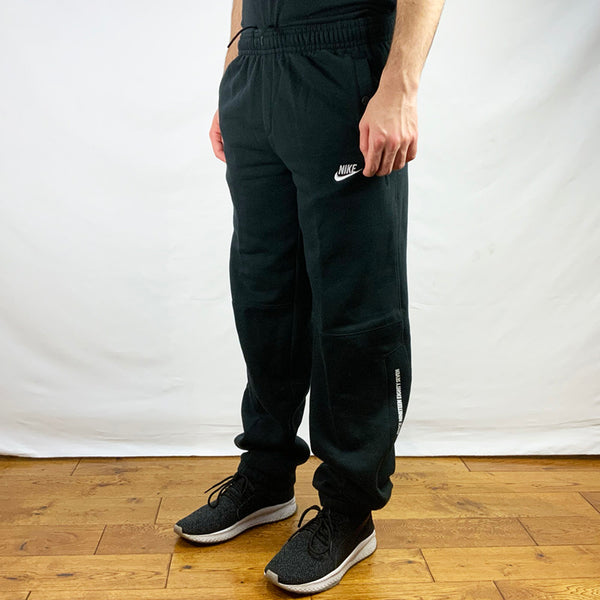 2008 Boys Deadstock Vintage Nike Joggers in Black with embroidered Nike branding. button pockets on side and cuffed hem. Adjustable drawstrings on waist. Condition: Brand new with tags  Measurements:   -  Size on Tag: Boys XL (fits adult small)  Inseam: 31.5 Inches  Length: 40.5 Inches  Waist: 28-33 Inches  All our items are of vintage conditions. This means some items may show signs of minor wear. Any major defects will be pictured and stated in the description