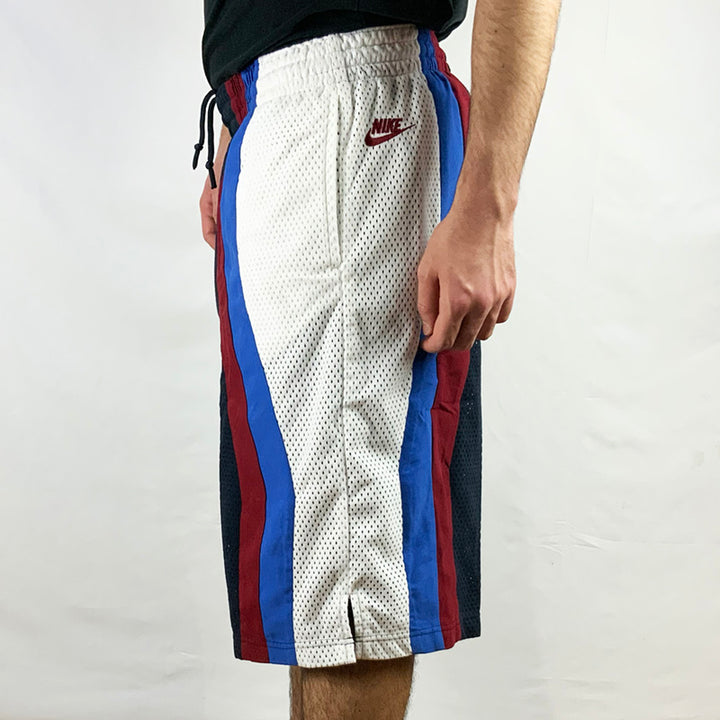 2006 Deadstock Vintage Nike FORCE Basketball Shorts in Navy Blue with embroidered Nike branding to side. White, Burgundy and Blue detailing. Mesh look. Adjustable drawstrings to waist. Colour: Navy Blue  Brand New with Tags  -  Size on Tag: Medium  Measurements:  Length: 24 Inches  Waist: GB 31/33 Adjustable drawstrings  All our items are of vintage conditions. This means some items may show signs of minor wear. Any major defects will be pictured and stated in the description