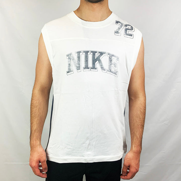 2004 Deadstock Vintage Nike Spellout Vest Top in white with Nike spellout across chest. Colour: White Brand New with Tags _ Size on Tag: Large Measurements:  Pit to Pit: 21 Inches Length: 27 Inches  All our items are of vintage conditions. This means some items may show signs of minor wear. Any major defects will be pictured and stated in the description
