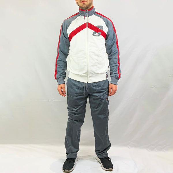 2003 Deadstock Vintage Nike Cortez tracksuit set in grey Full zip closure and pockets available on track top. The matching pants have an adjustable drawstring for a customised wear, as well as side pockets to keep your essentials. Nike Cortez branding detailed on track top and track bottoms.  Colour: Grey  Brand New with Tags  Size on Tag: Medium