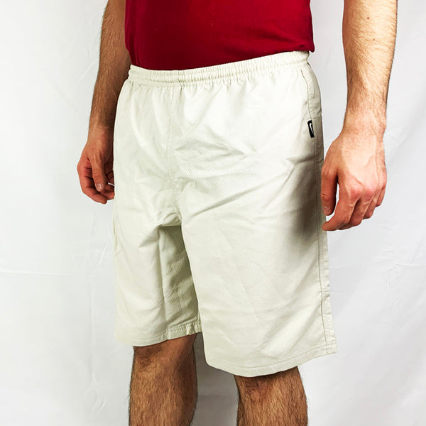2004 Deadstock Vintage Nike Football Dri-Fit shorts in cream. Nike branding to side. Adjustable drawstring to waist. Zip pocket on side. Colour: Cream  Brand New with Tags  -  Size on Tag: Medium  Measurements:  Length: 19.5 Inches  Waist: GB 31/33  All our items are of vintage conditions. This means some items may show signs of minor wear. Any major defects will be pictured and stated in the description