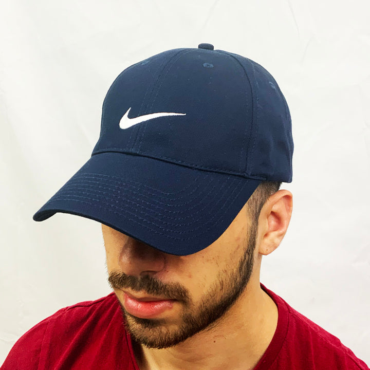 Y2k Deadstock Vintage Nike Swoosh Cap in Navy Blue with embroidered Nike Swoosh to centre. Hat is adjustable at back. Colour: Navy Blue Brand New with Tags  -  Size on Tag: Adult Unisex  All our items are of vintage conditions. This means some items may show signs of minor wear. Any major defects will be pictured and stated in the description