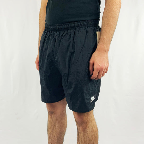 90s Deadstock Vintage Nike Spellout shorts in black with Nike spellout to front and large spellout to back. Adjustable drawstring to waist. Pocket to sides. Colour: Black  Brand New with Tags  -  Size on Tag: Large  Measurements:  Length: 17 Inches  All our items are of vintage conditions. This means some items may show signs of minor wear. Any major defects will be pictured and stated in the description
