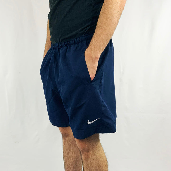 2002 Deadstock Vintage Nike Football shorts in navy blue with Nike swoosh to front. Adjustable drawstring to waist. Pocket to sides. Colour: Navy Blue  Brand New with Tags  -  Size on Tag: Large  Measurements:  Length: 17 Inches  Wait: GB 34/36  All our items are of vintage conditions. This means some items may show signs of minor wear. Any major defects will be pictured and stated in the description