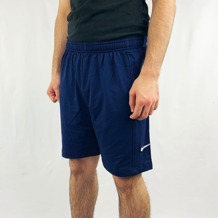 90s Deadstock Vintage Nike Team shorts in navy blue with Nike swoosh to side. Adjustable drawstring to waist. Colour: Navy Blue  Brand New with Tags  -  Size on Tag: Large  Measurements:  Length: 18 Inches  All our items are of vintage conditions. This means some items may show signs of minor wear. Any major defects will be pictured and stated in the description