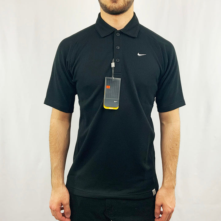 2005 Deadstock Vintage Nike Court Polo T-shirt in black with embroidered Nike swoosh to chest. Nike Court branding to waist. Colour: Black  Brand New with Tags  _  Size on Tag: Small  Measurements:  Pit to Pit: 21 Inches  Length: 27.5 Inches  All our items are of vintage conditions. This means some items may show signs of minor wear. Any major defects will be pictured and stated in the description